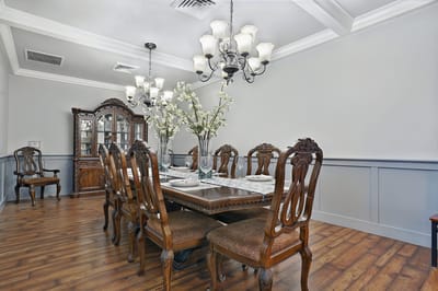 Elegant dining room with a large wooden table and decorative chairs