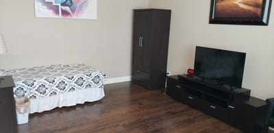 A private resident room with a bed and television