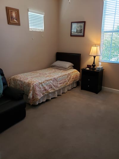 Cozy private room with a bed and lamp