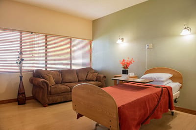 Cozy resident room with a bed and sofa