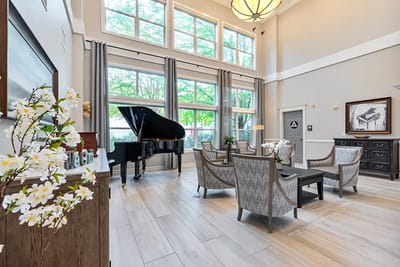 Bright and inviting common area with piano and seating