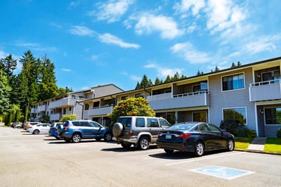 Exterior view of a senior living facility with parking