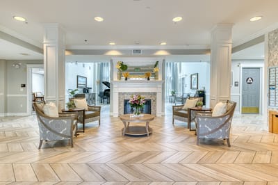 Bright lobby with seating and fireplace in a senior living facility