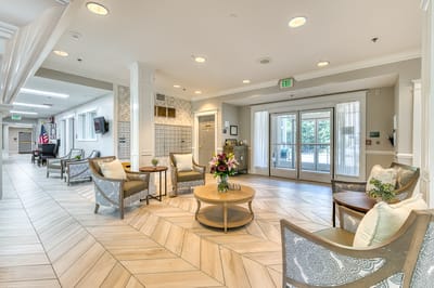 Bright common area with seating and floral arrangements