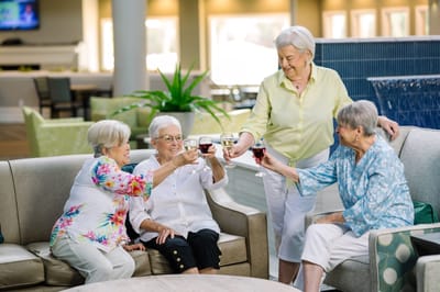 Four residents enjoying drinks in a common area