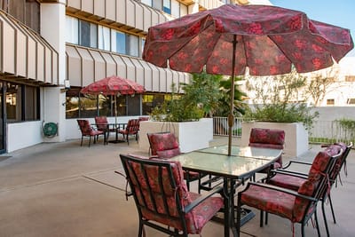 Outdoor patio area with seating and umbrellas