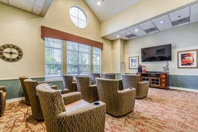 Bright common area with seating and a TV