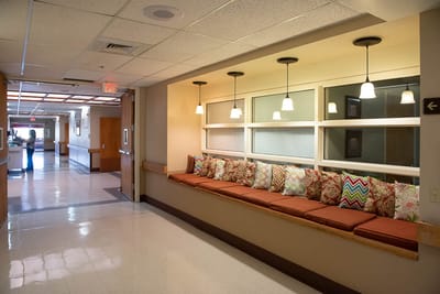 Interior hallway with seating and decorative pillows