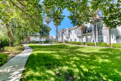 Landscaped outdoor area with walking path and seating