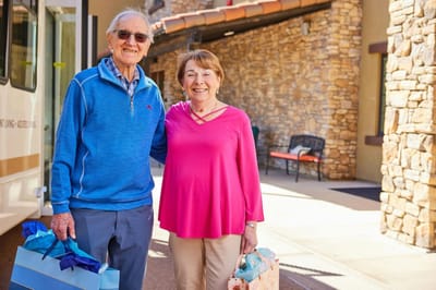 Two residents smiling outside the facility
