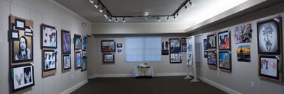 An interior art gallery with framed artworks on the walls