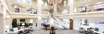 Bright common area with a grand staircase and seating