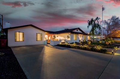 Exterior view of Southwest Comfort Care building at sunset