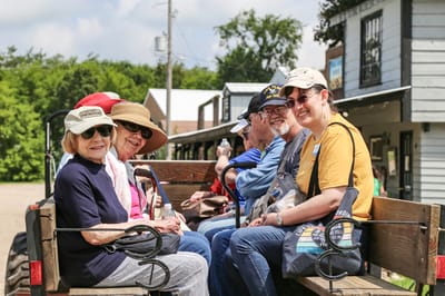 Residents enjoying a sunny outing on a wagon ride