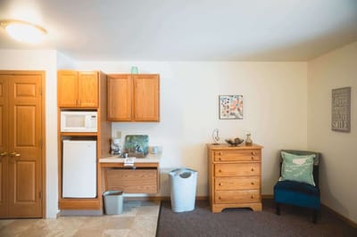 Bright interior view of a resident's room with kitchenette