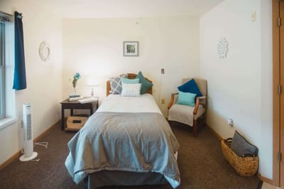 Cozy private resident room with bed and decor