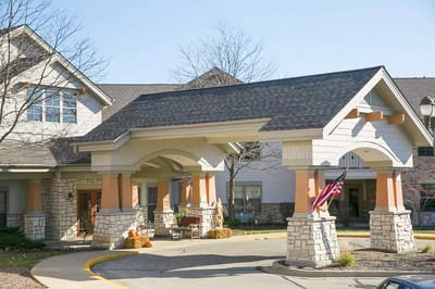 Front entrance of Riverview Village Senior Living with flag.
