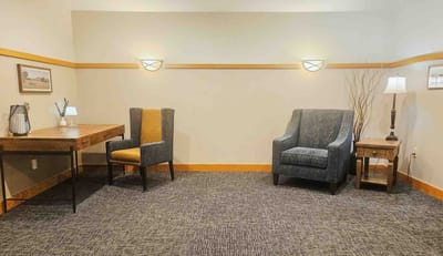 A cozy interior sitting area with chairs and a desk