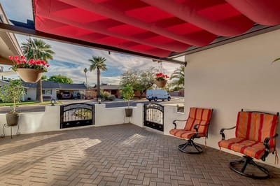 Outdoor seating area with colorful chairs and potted plants