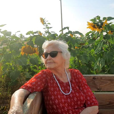 Senior woman enjoying a sunny outdoor garden