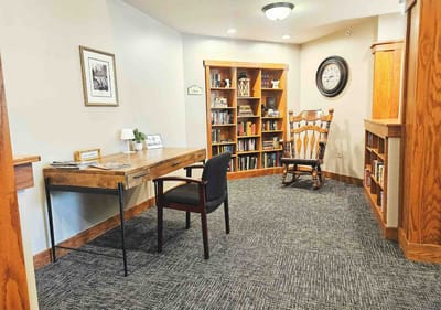 Cozy common area with bookshelves and a rocking chair