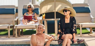 Residents enjoying the pool area on a sunny day