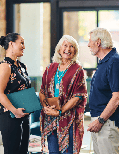 Residents and staff conversing in a common area