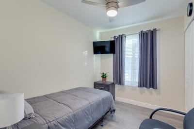 Simple resident room with a bed and TV
