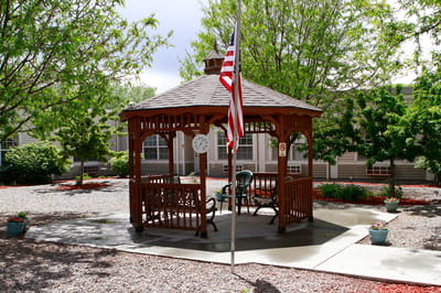 Outdoor gazebo area with seating and flag