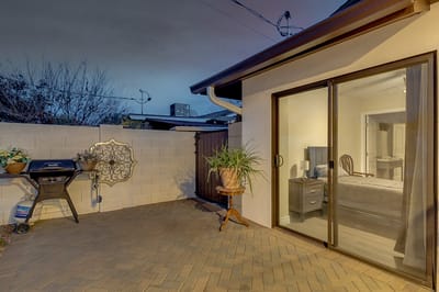 Outdoor patio space with a grill and potted plants
