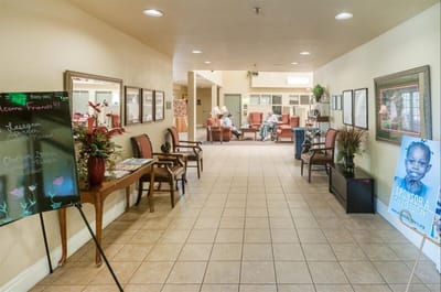 Interior hallway with seating areas and residents