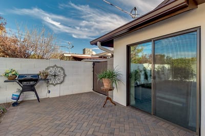 Quaint outdoor patio with grill and plants