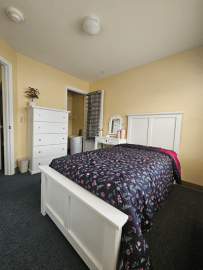 Cozy bedroom with floral bedding and dresser