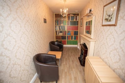 Cozy reading nook with bookshelves and chairs