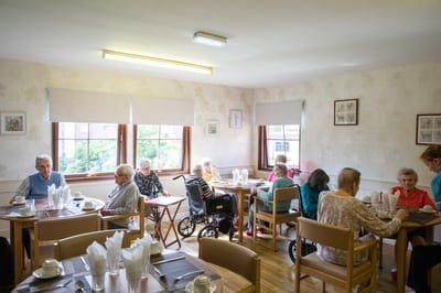 Residents engaging in activities in a dining room