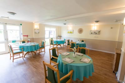 Bright dining room setup with tables and chairs