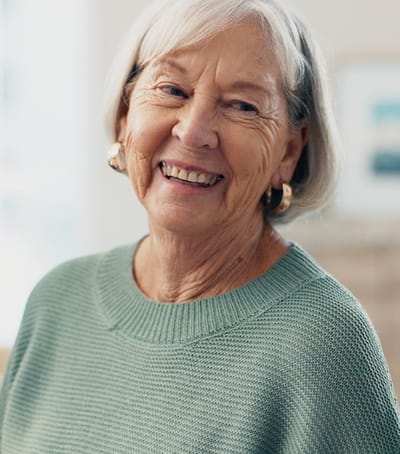 Smiling senior woman in a cozy interior