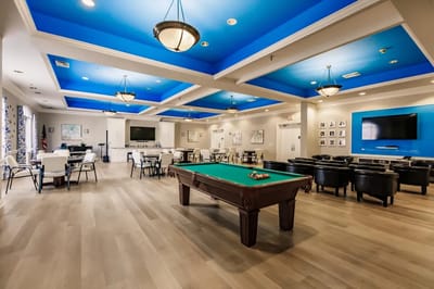 Bright common area with a pool table and seating