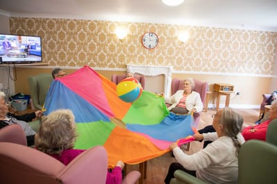 Residents engaging in a colorful group activity indoors
