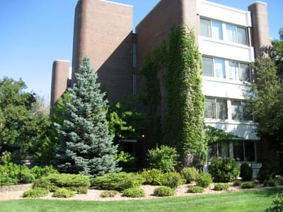 Exterior view of a senior living facility surrounded by greenery
