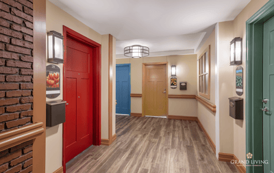 Bright hallway with colorful doors in a senior living facility
