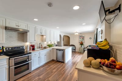 Bright kitchen with fruits and cooking area