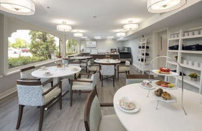 Bright dining room with tables set for tea and snacks