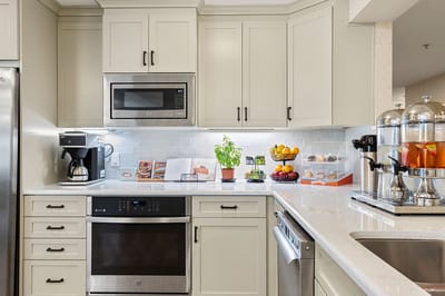 Modern kitchen area with coffee and fruit display