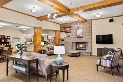 Bright common area with seating and a fireplace