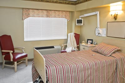 Cozy resident room with a bed and seating area