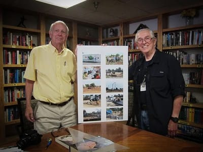 Two men presenting a collage of photos in a library-like setting