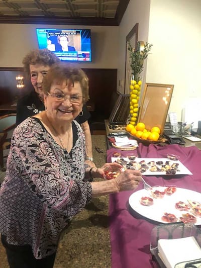 Residents enjoying a food activity in a common area