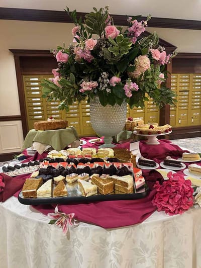 A beautifully arranged dessert table with floral centerpiece