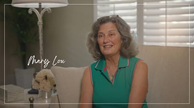 Resident smiling in a comfortable living space